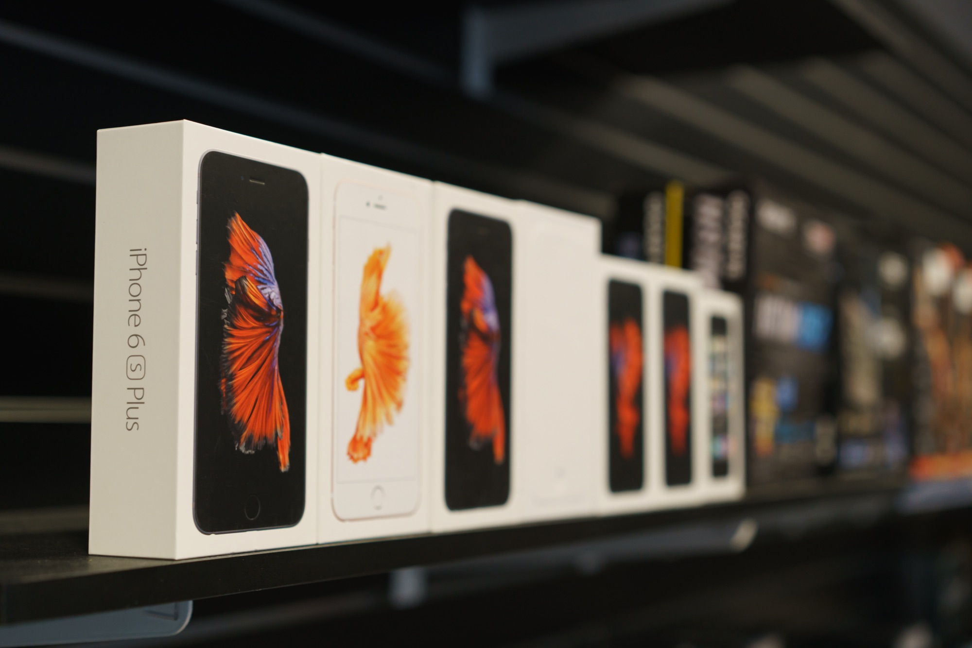 Boxed iPhones lined up on a shelf